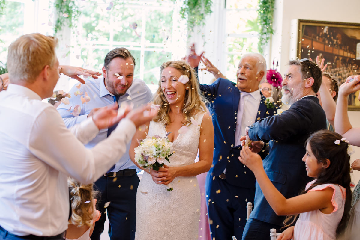 Bride and groom confetti throw after ceremony