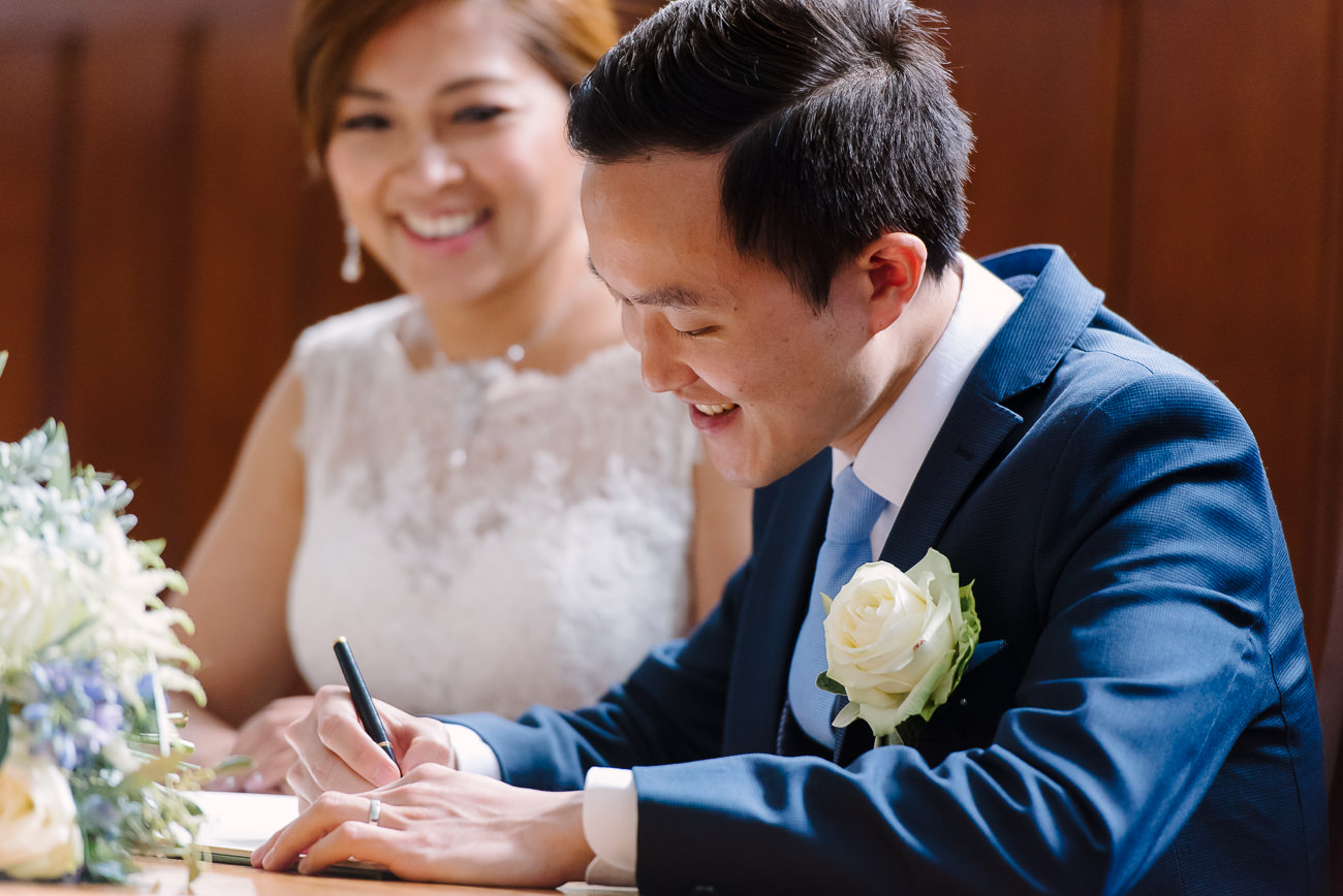 Bride and Groom signing the registry at Guildhall Kingston Upon Thames