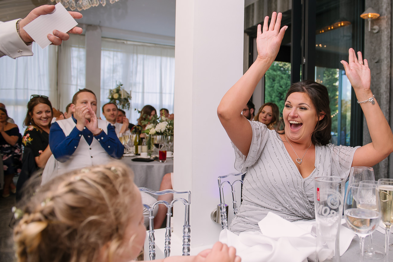 Bridesmaid joyful with hands raised up in the air at Russets Country House 