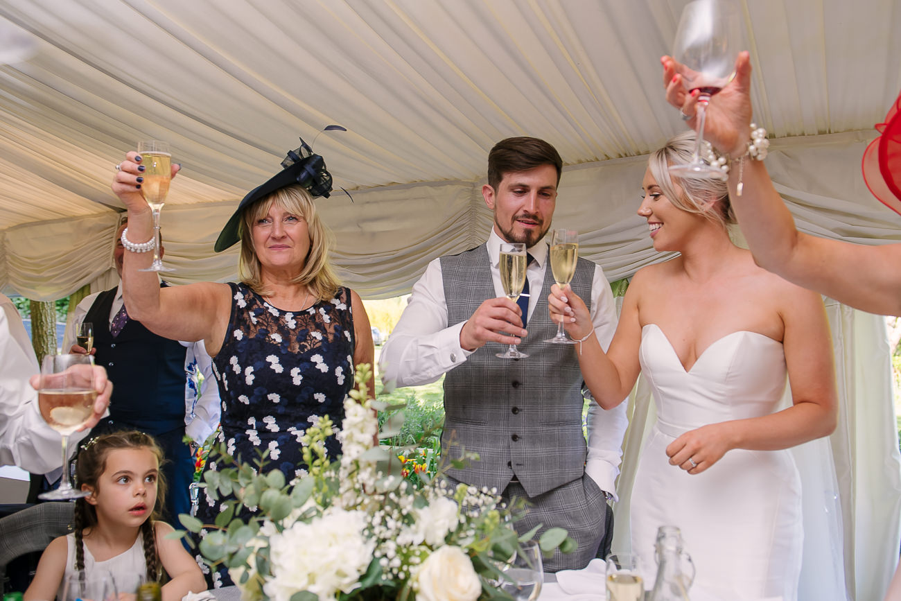 Bride, groom and family toasting during speeches at Russets Country House 