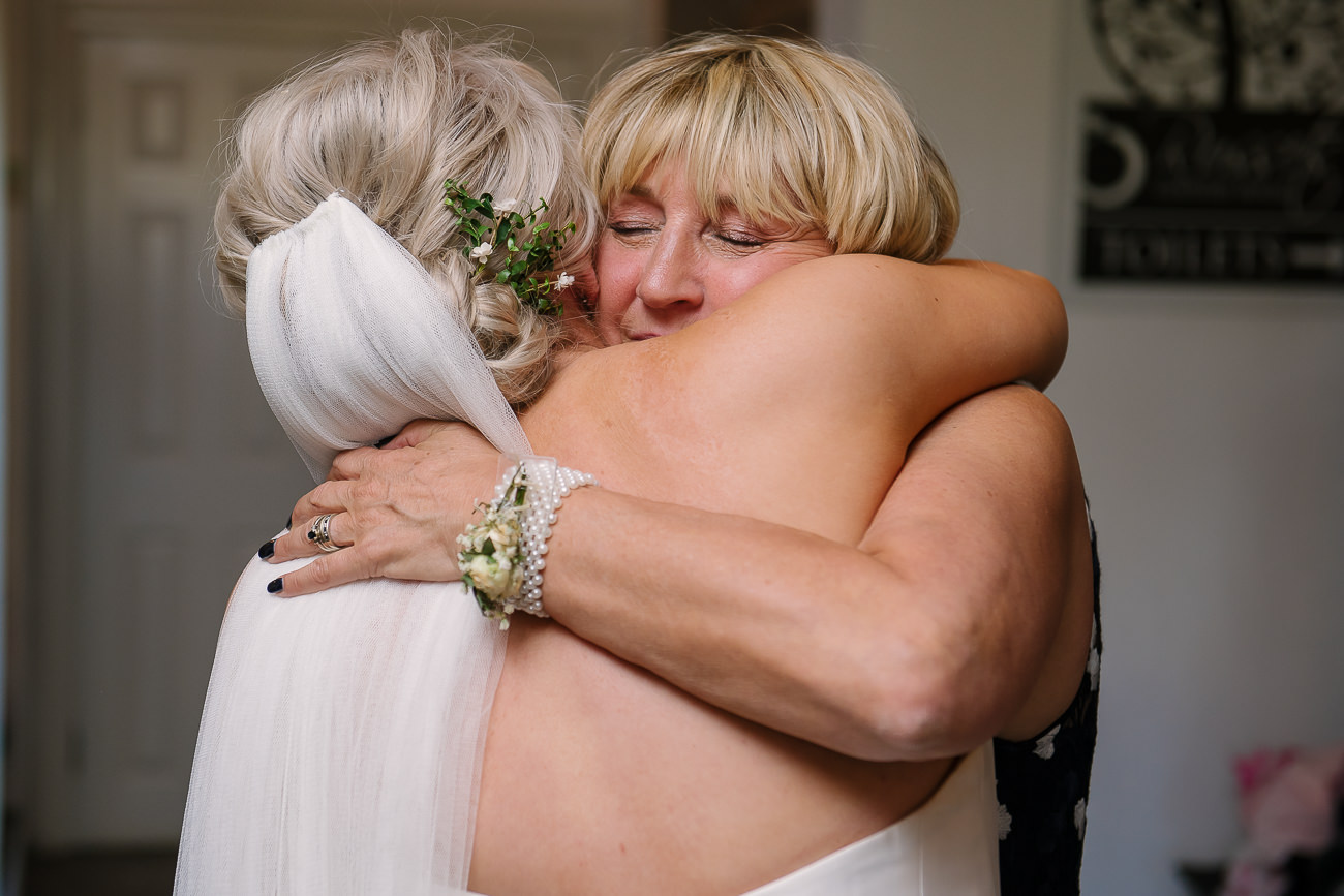 Mother of the groom emotional hugging the bride after after speeches at Russets Country House