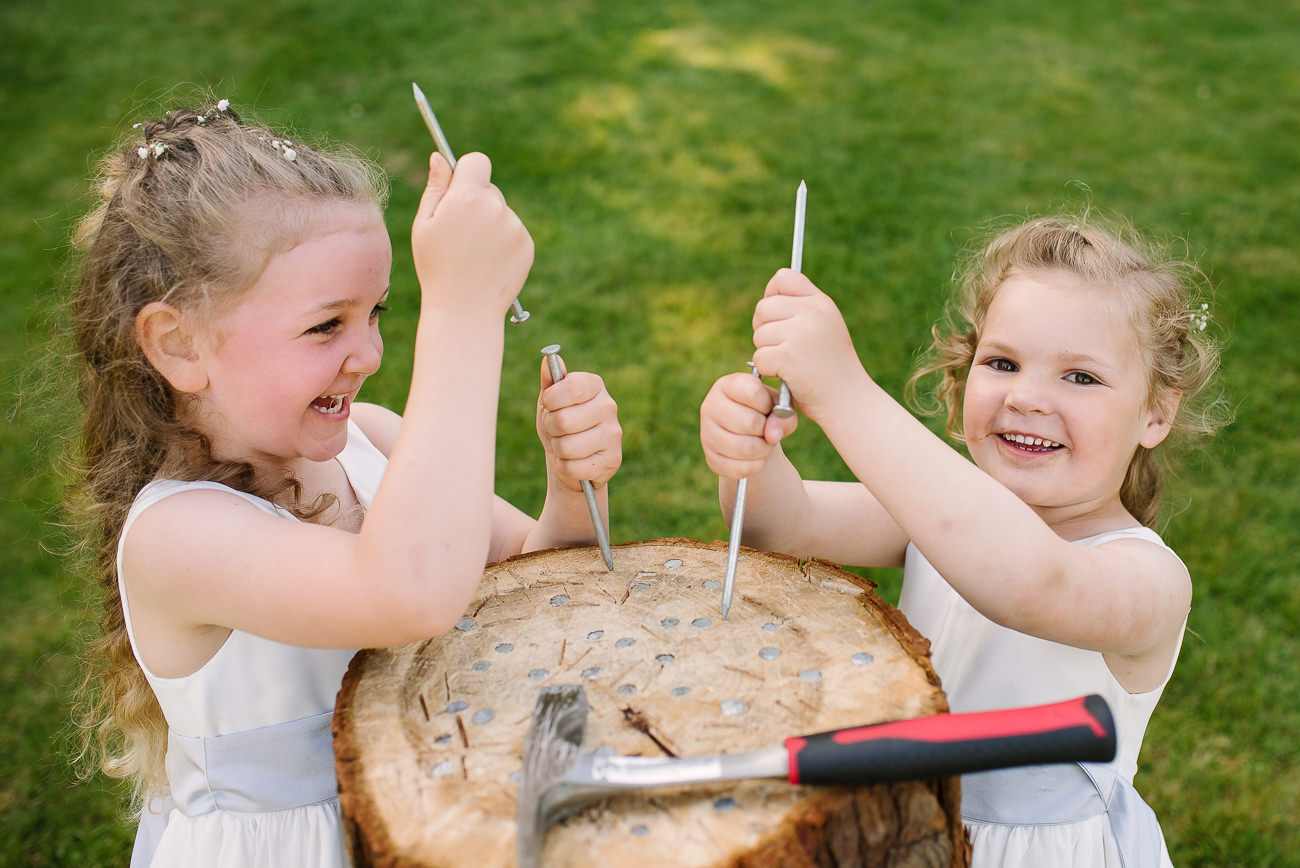 Cheeky flower girls playing with long nails, pretending to play stump