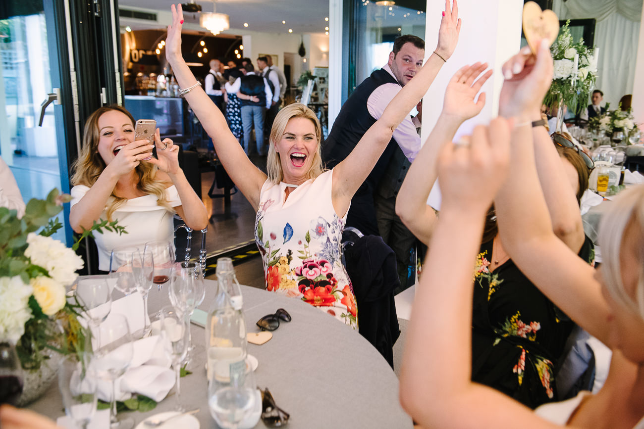 Wedding guests cheering and laughing at Russets Country House reception