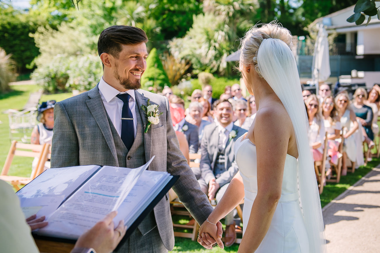 Groom takes bride’s hand and smiles at Russets Country House 