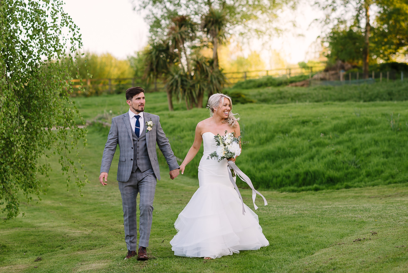 Bride and groom walking on lawn at Russets Country House