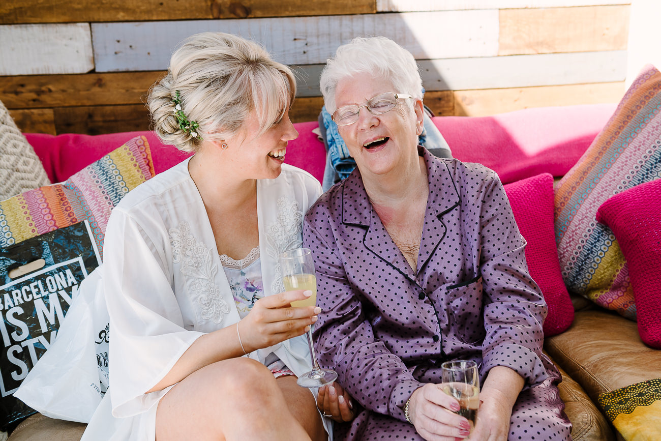 Bride with grandmother having fun during wedding preps