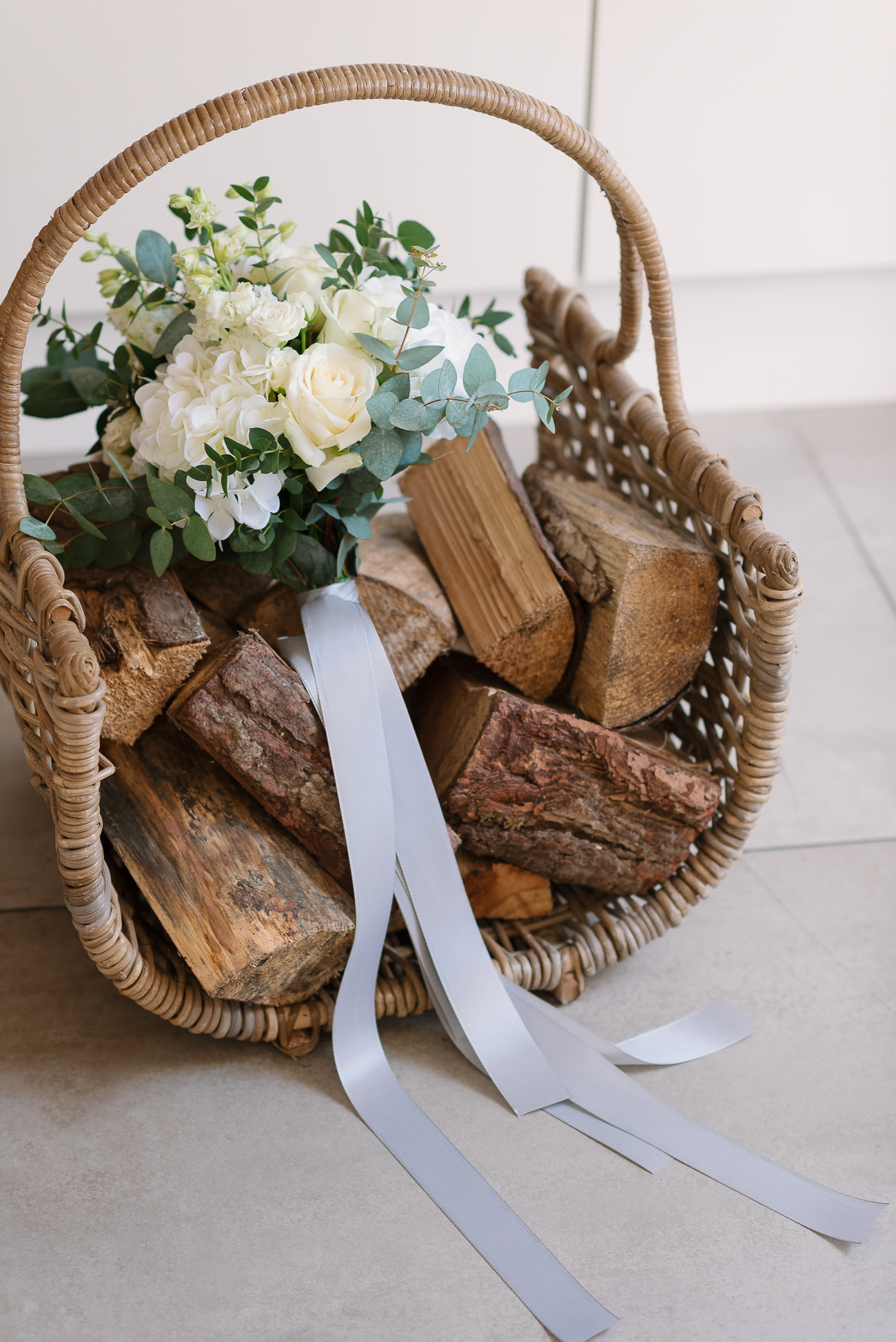 Lovely bouquet white flowers on logs tight with a silver ribbon