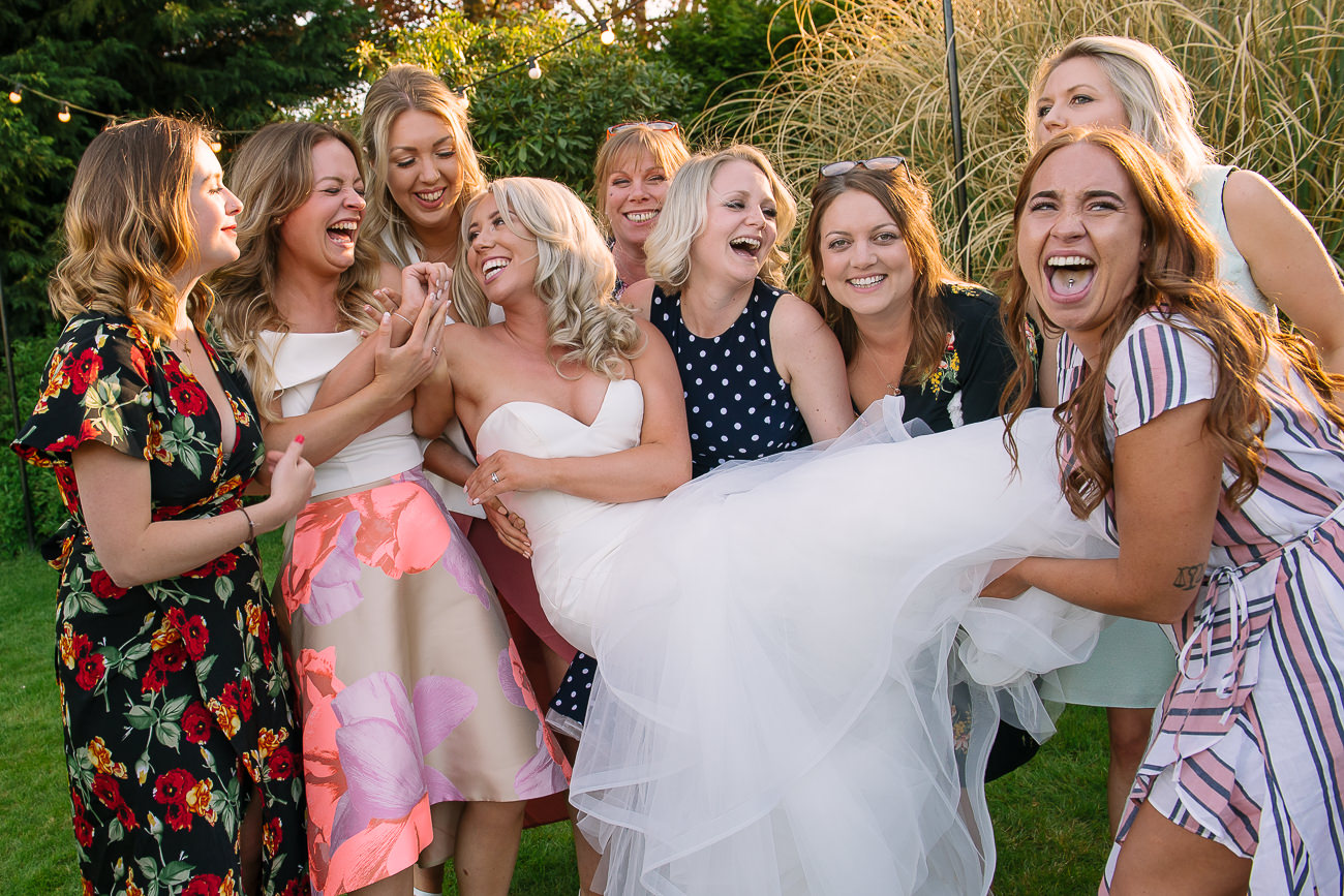 Girls lifting the bride in fish pose at Russets Country House