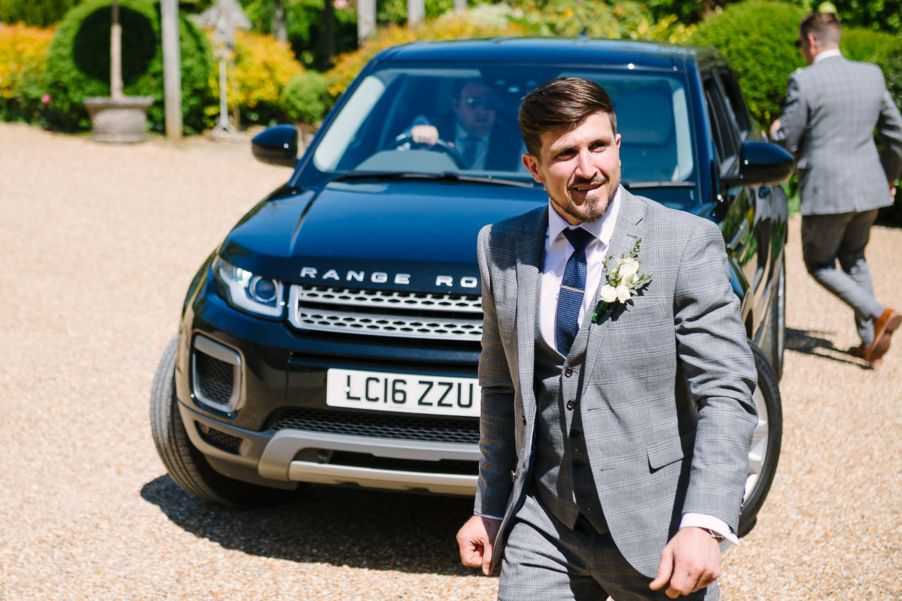 Groom arriving at ceremony with a black car 