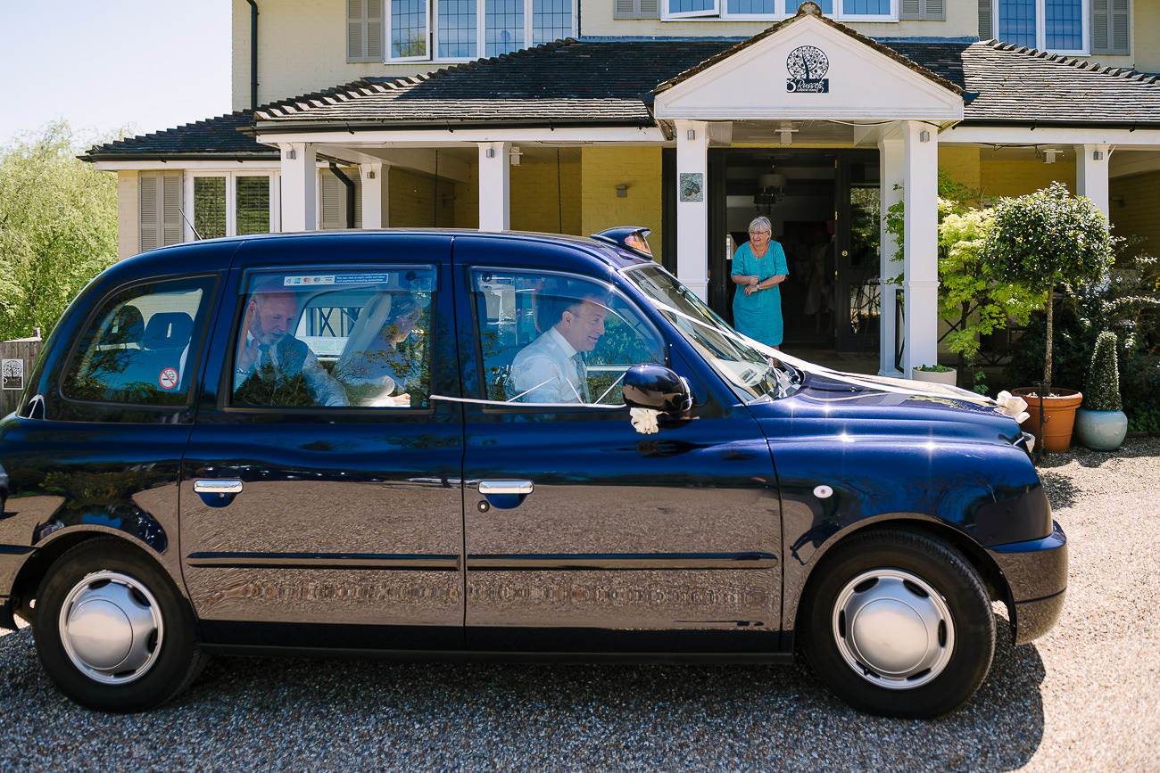 Bride arrives at Russets Country House in a blue cab car