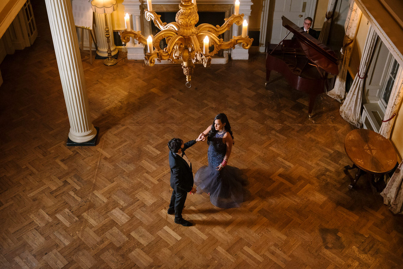 Hampton Court House Wedding photography of bride & groom from upstairs as they are dancing in the middle of the room