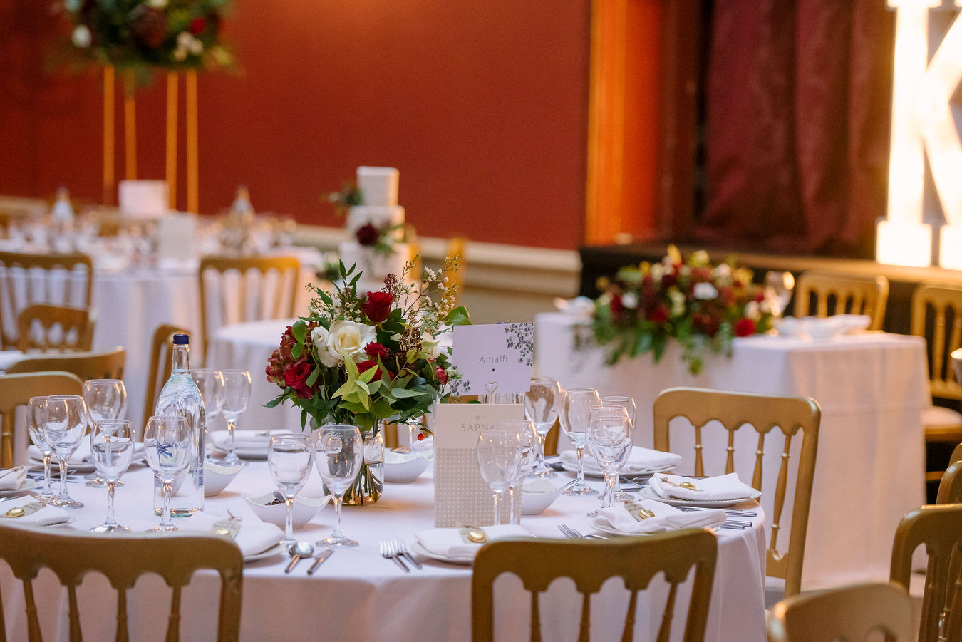 Tables setting with glasses, plates and cutlery by Sapna Asian Catering at Hampton Court House.