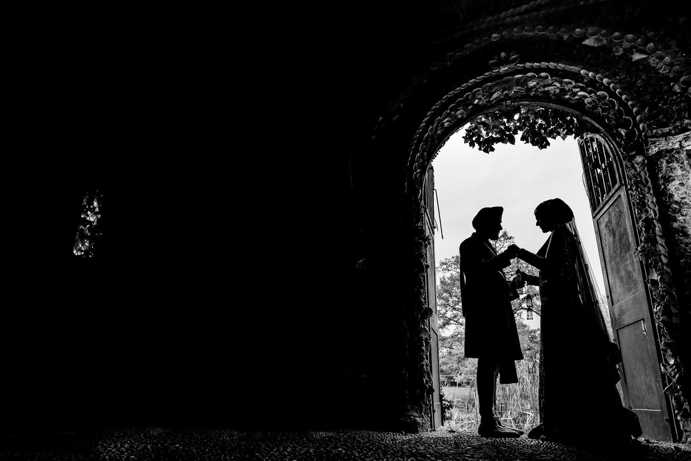 Black and white silhouette photography of bride and groom at Hampton Court House