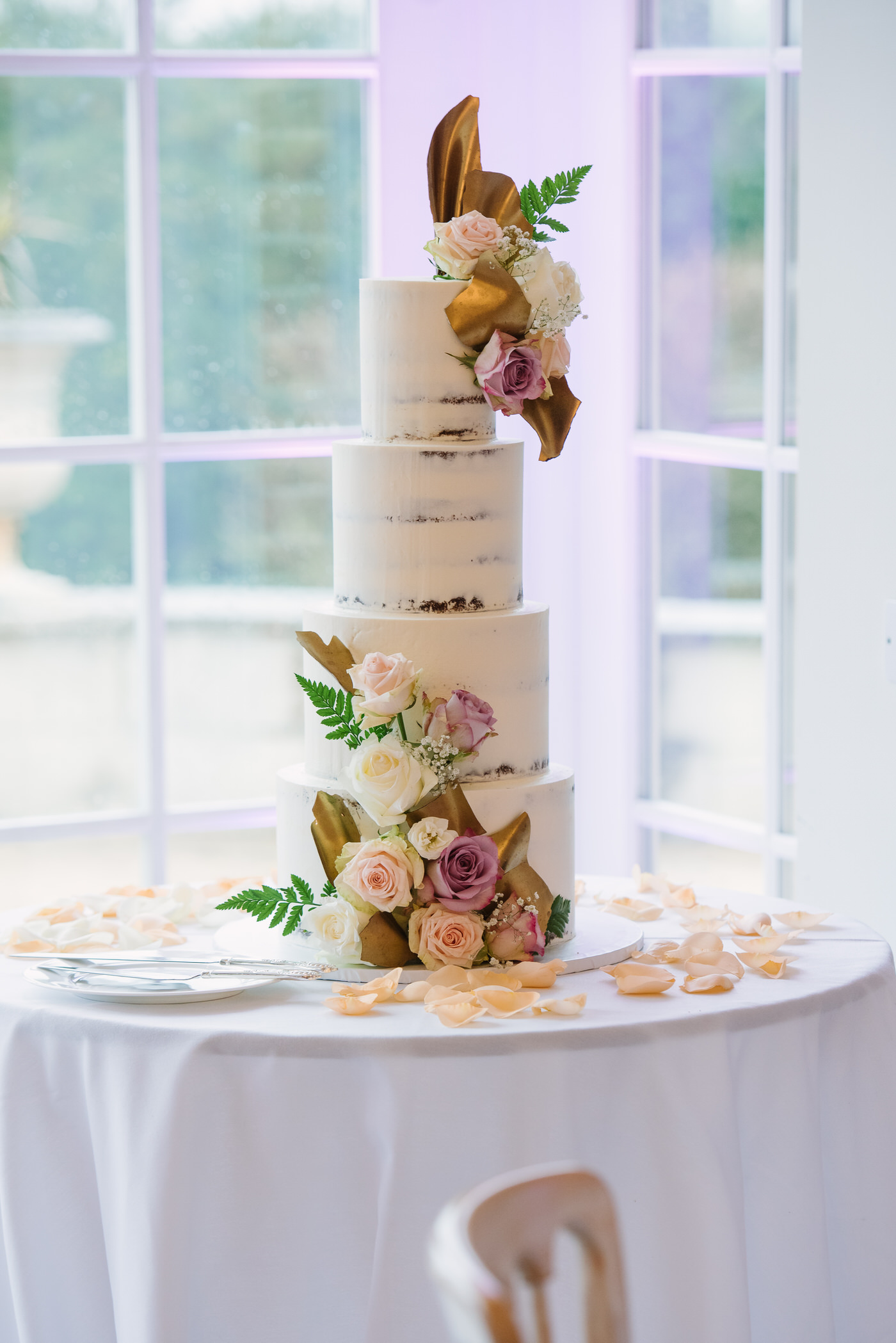 Wedding cake naked decorated with flowers at Froyle Park Surrey