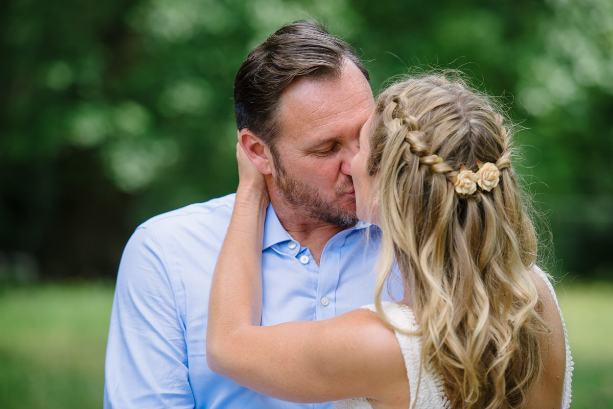 Bride and groom kissing - bridal hair inspiration