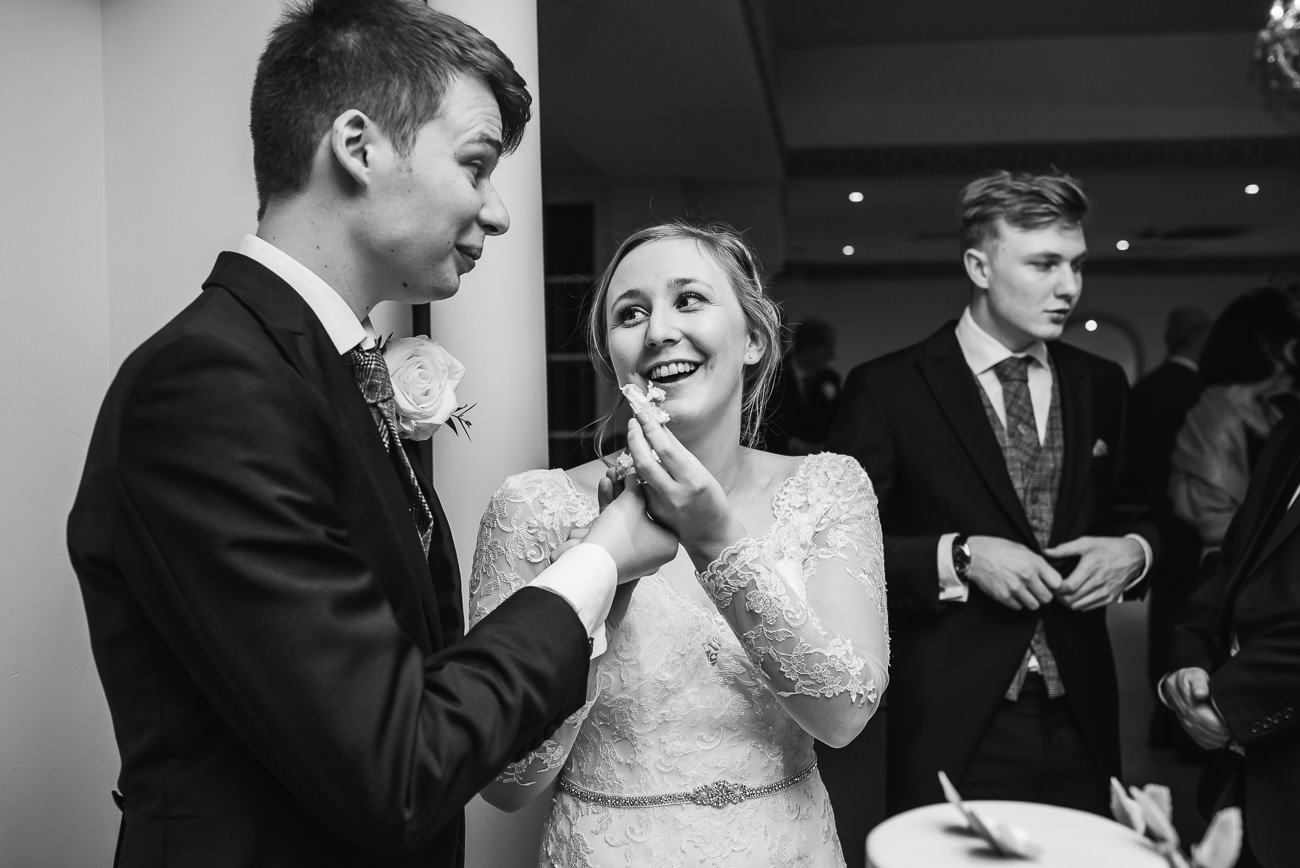 Bride and Groom enjoying cake at Froyle Park 