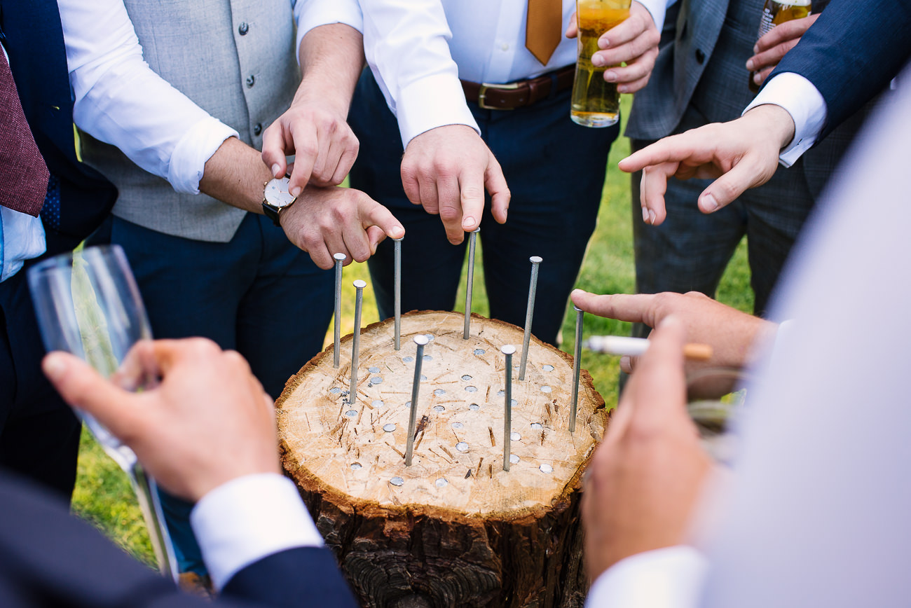 Wedding guest hands playing stump drinking game at Russets Country House
