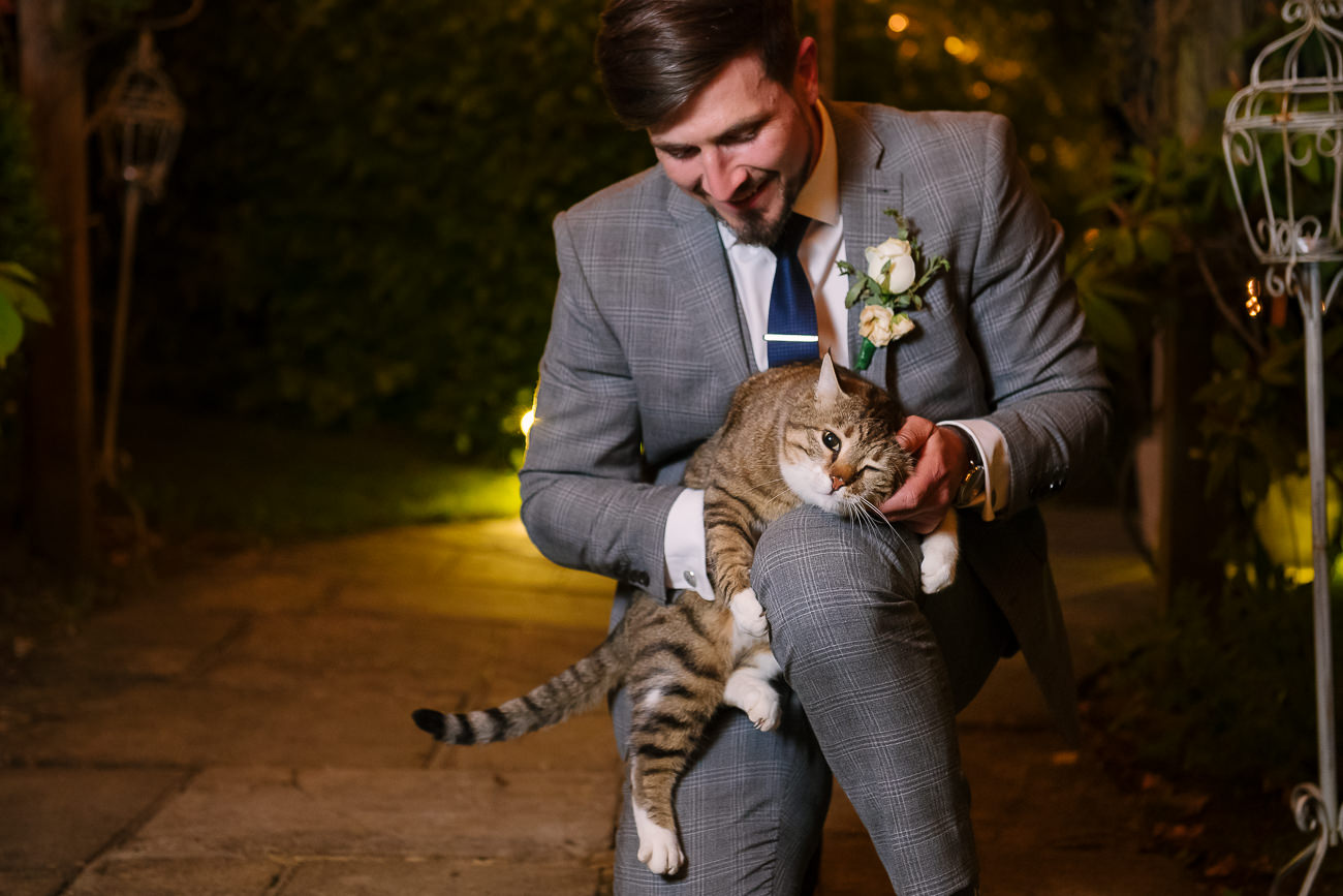 Groom petting the cat at Russets Country House 