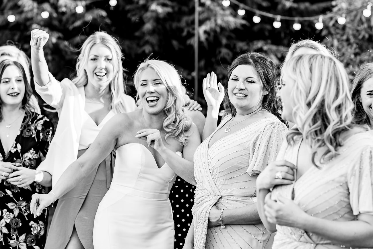 Bride along with bridesmaids taking a group photo at Russets 