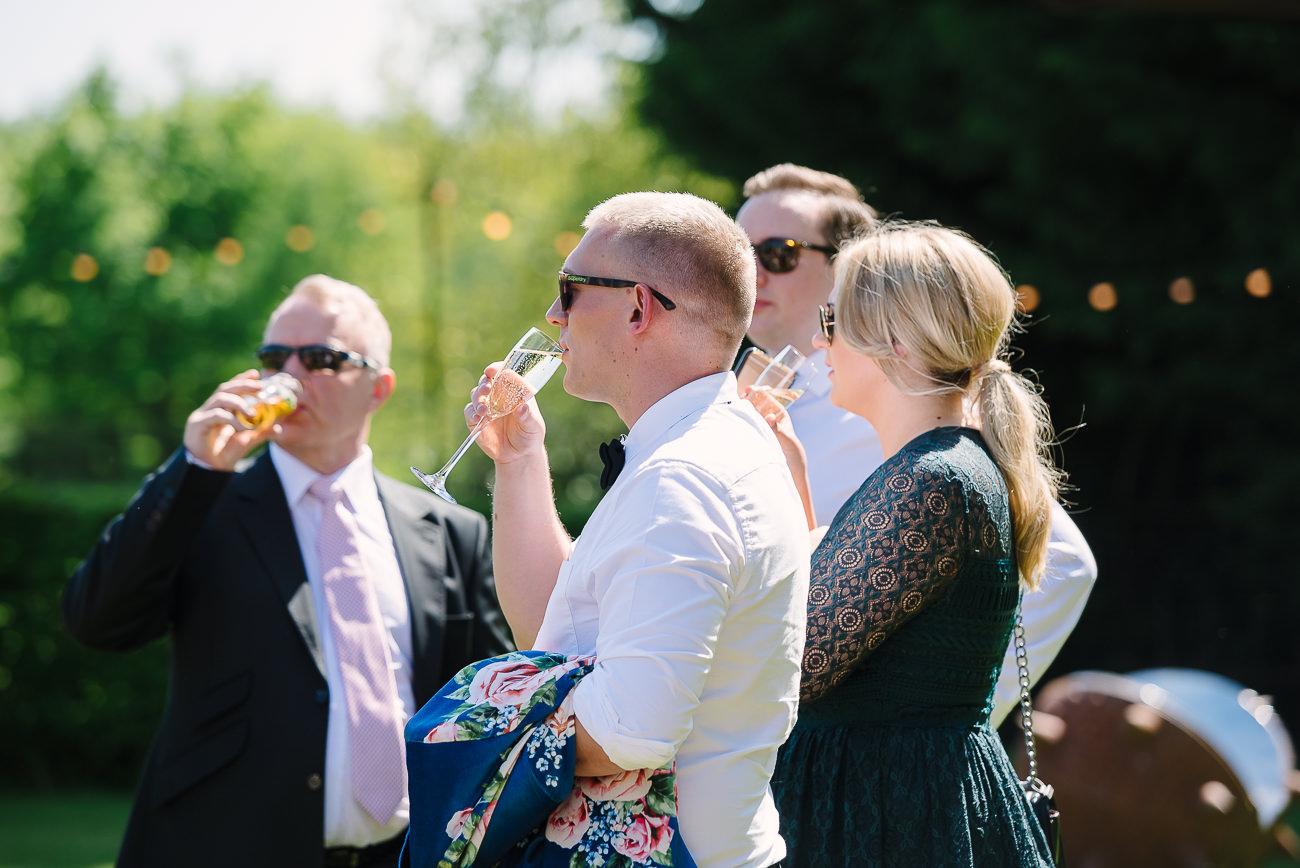 Wedding guests sipping drinks and enjoying the grounds at Russets Country House