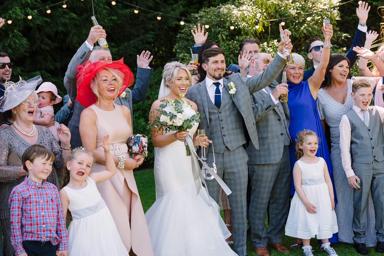 Family group photograph with bride and groom in the middle