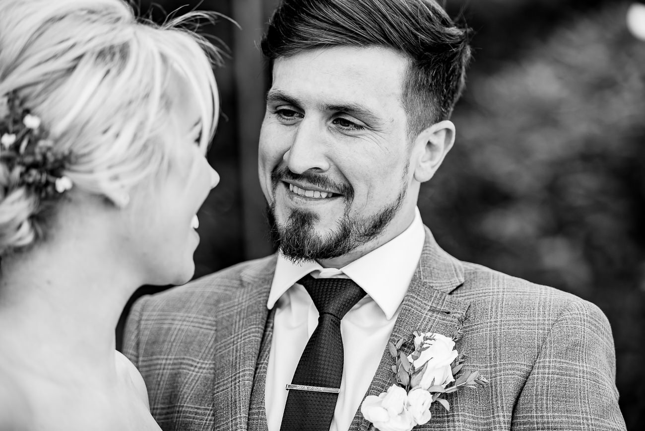 Groom lovingly looking at his bride portrait at Russets Country House