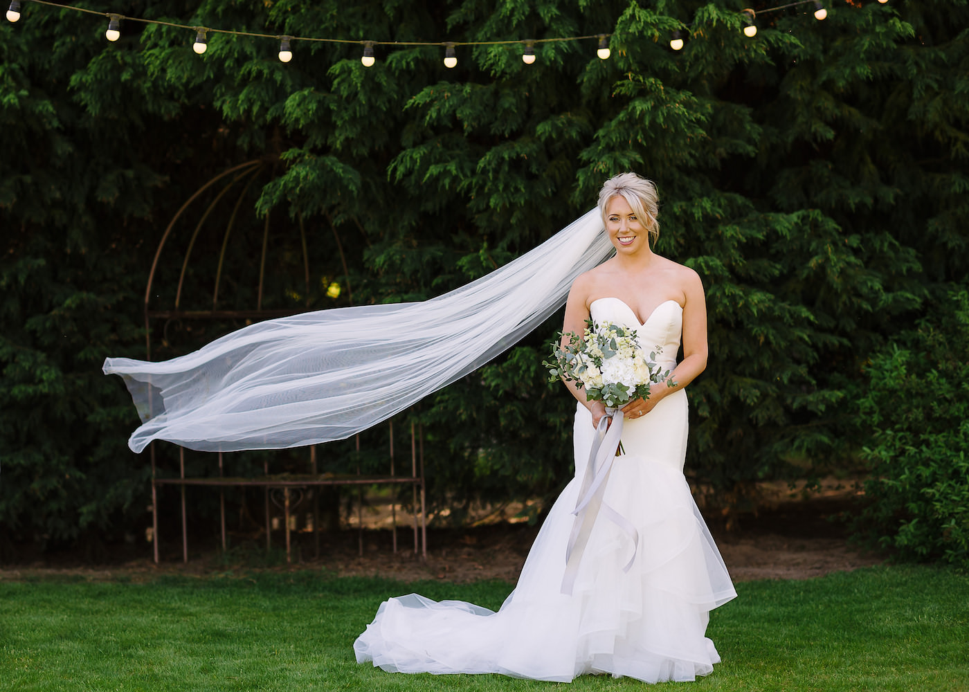 Bride’s long white veil lifted by wind at Russets Country House