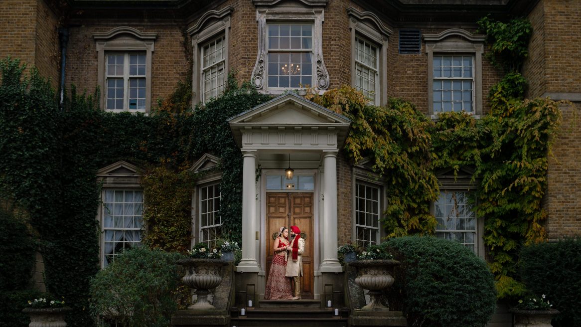 Wedding photography Asian bride & groom in front of Hampton Court House